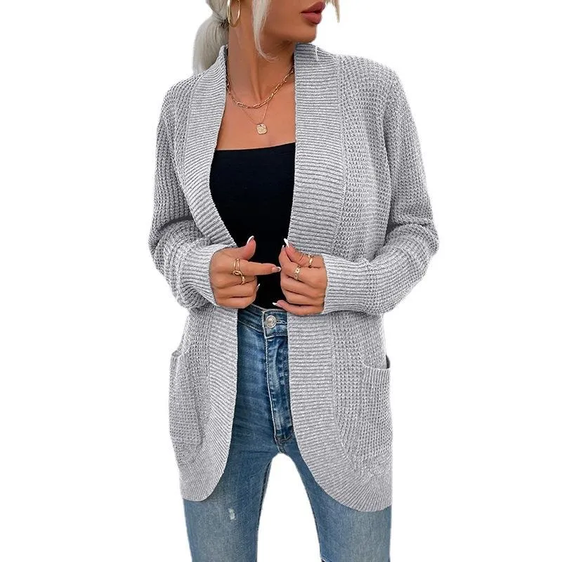 Ladies' knitted sweater with curved pockets at hem